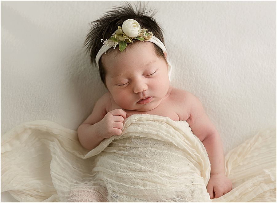 baby girl on a cream colored background