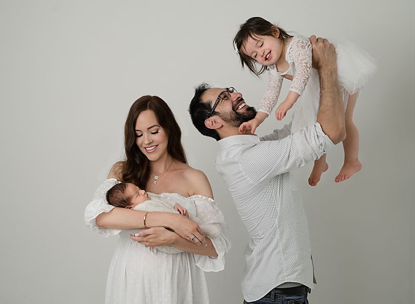family photos of newborn boy with sibling and parents