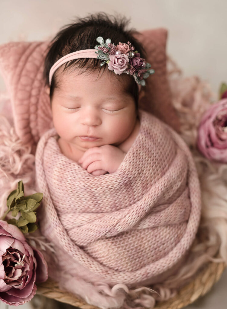 baby girl wrapped in pink