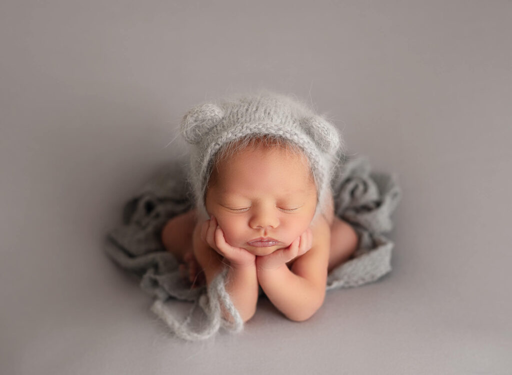 baby boy laying in gray posed in froggy