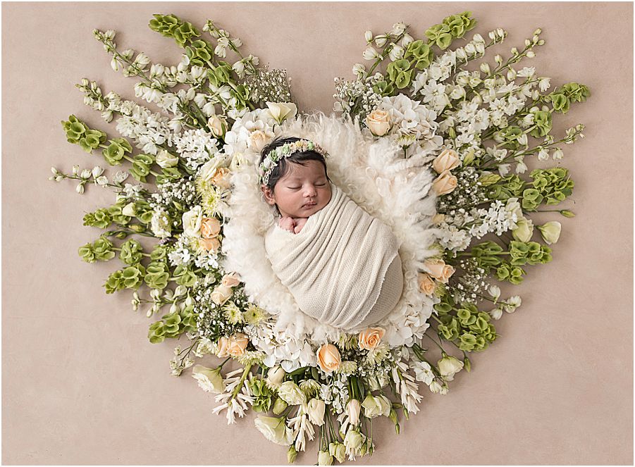 baby surrounded by flowers
