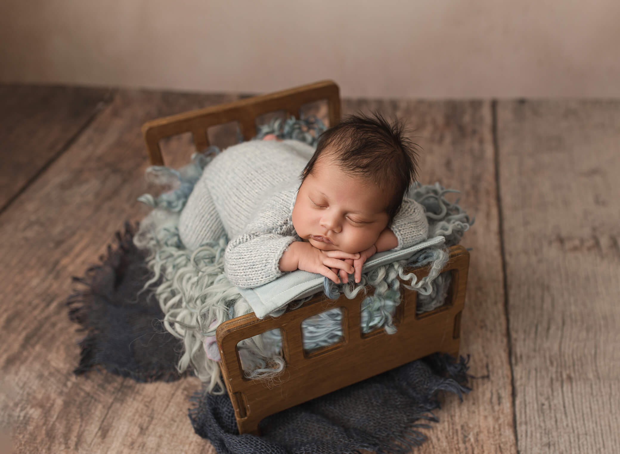 baby laying on a bed