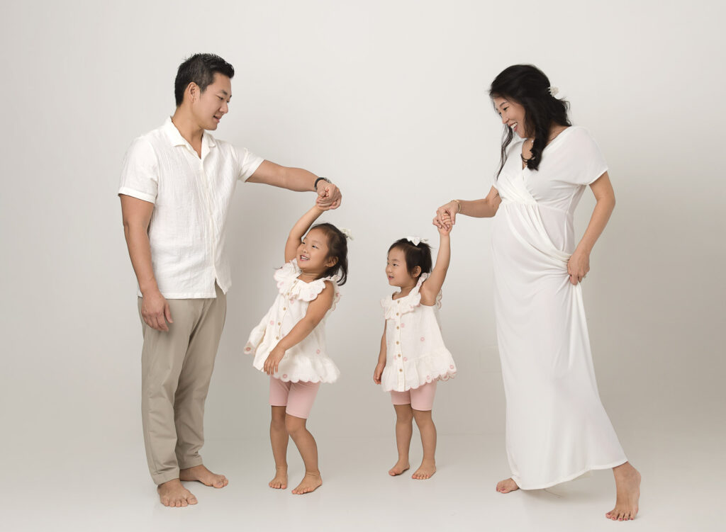 lifestyle two girls dancing with mom and dad