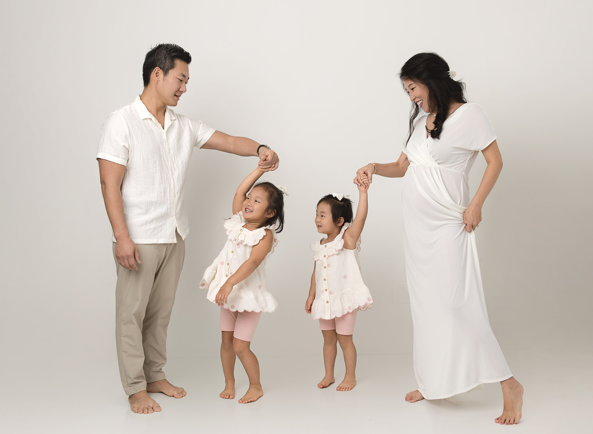 lifestyle two girls dancing with mom and dad