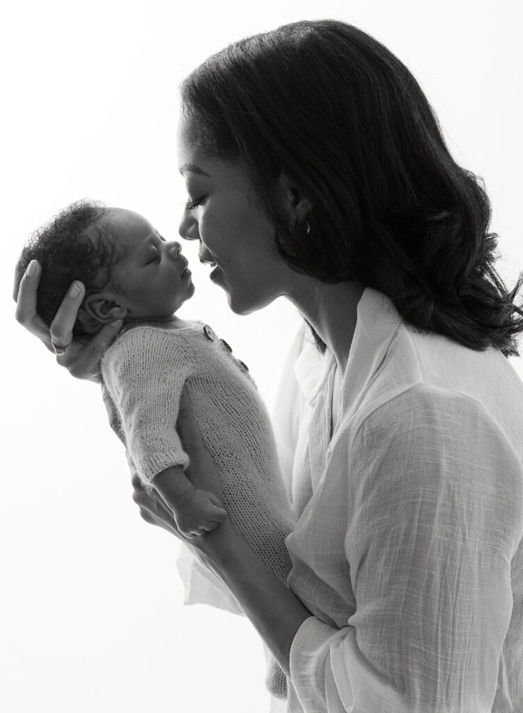 Parent holding newborn close during Sandy Springs, GA newborn photography session
