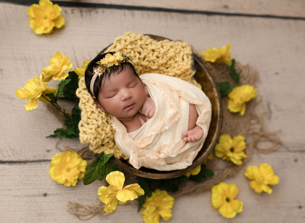 Swaddled newborn sleeping peacefully in Sandy Springs, GA newborn photographer’s studio